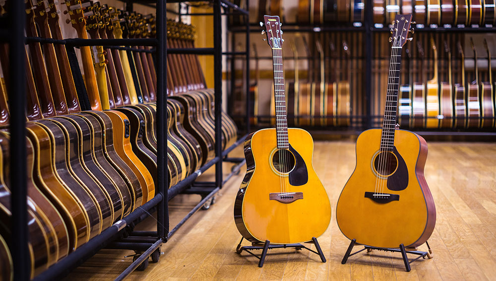 2 guitars displayed in a guitar showroom.