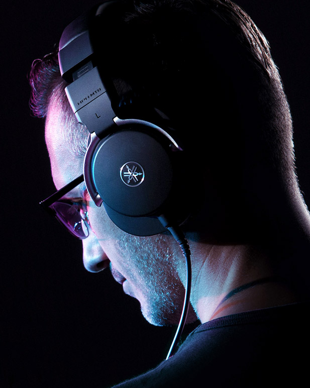 Side profile of person wearing Yamaha Pro Audio headphones.
