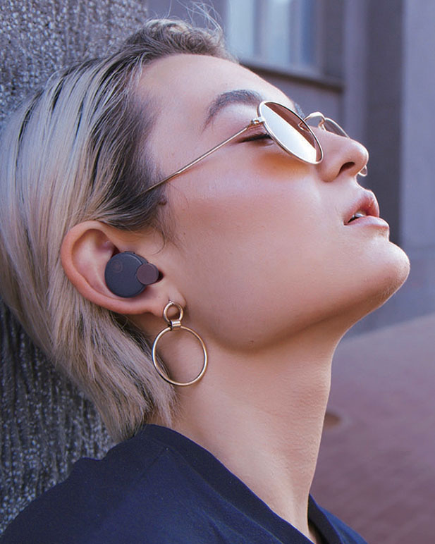 Side profile showing a person wearing a Yamaha true wireless earbud.