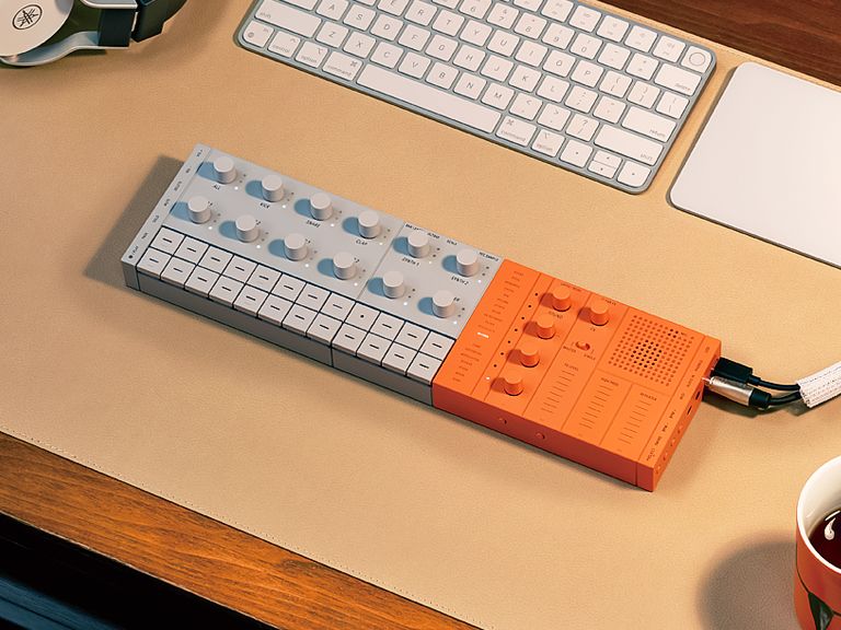 SEQTRAK orange placed on a desk and plugged into a computer.
